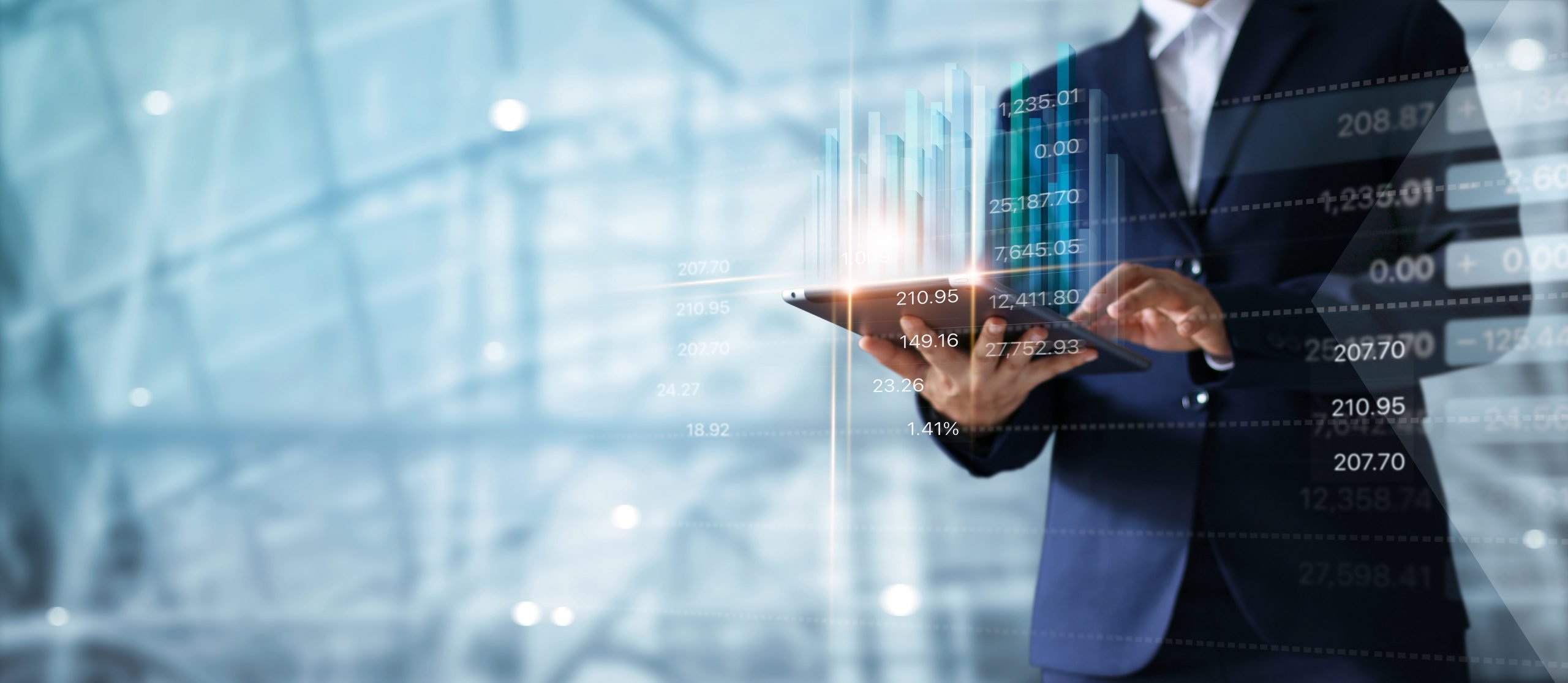 Businessman using tablet analyzing sales data and economic growt